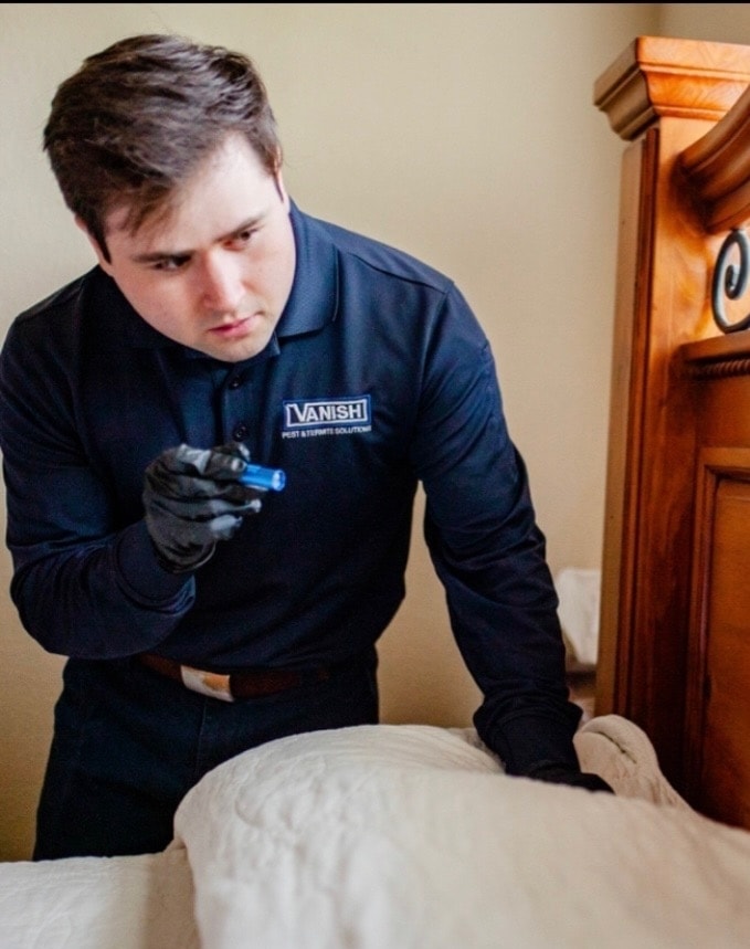 Vanish technician performing bed bug inspection